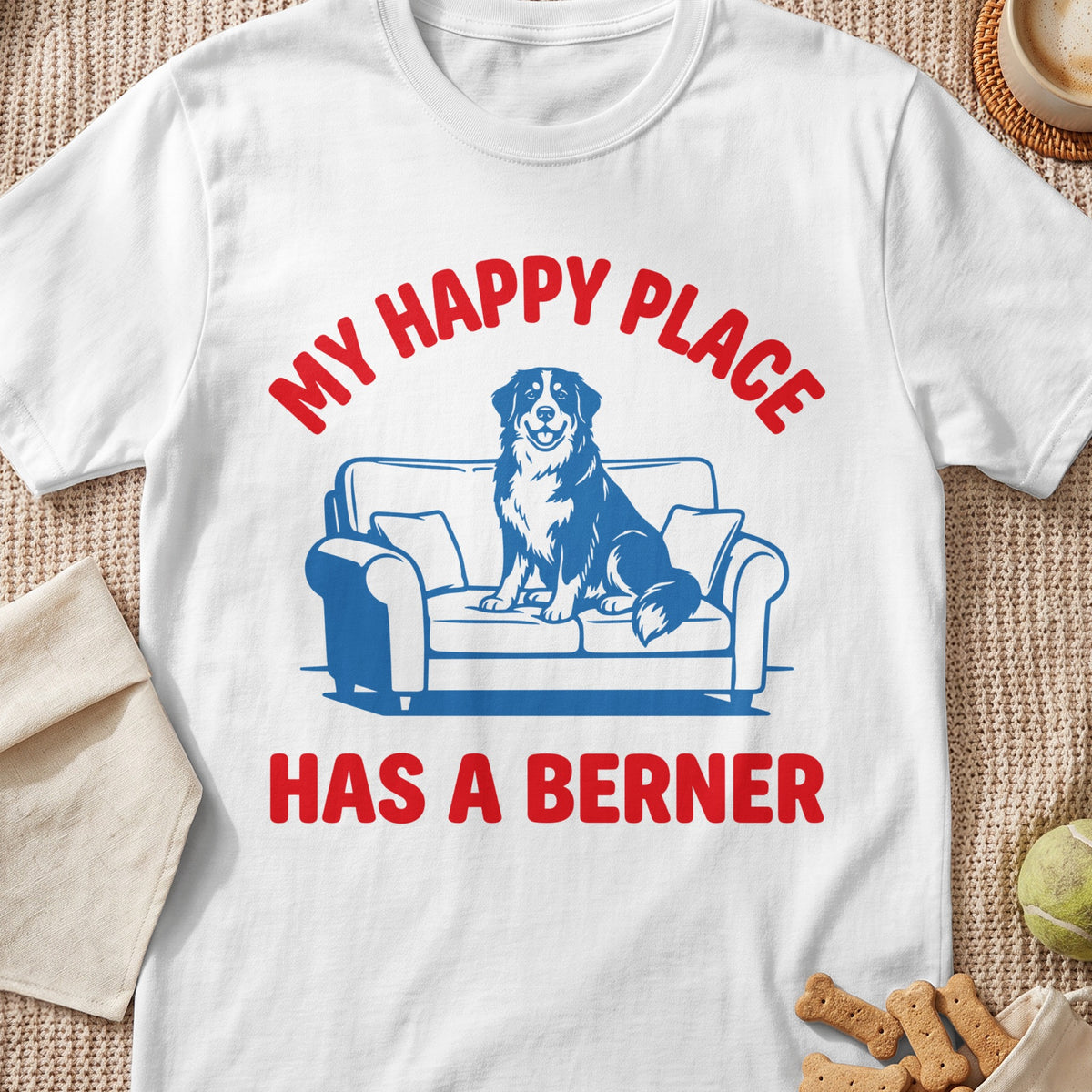 White t-shirt with red text "MY HAPPY PLACE HAS A BERNER" and blue dog on couch graphic.