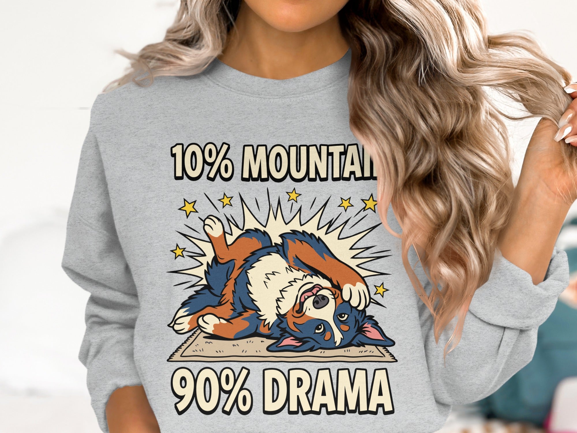 Grey sweatshirt with a cartoon dog and text "10% MOUNTAIN 90% DRAMA".