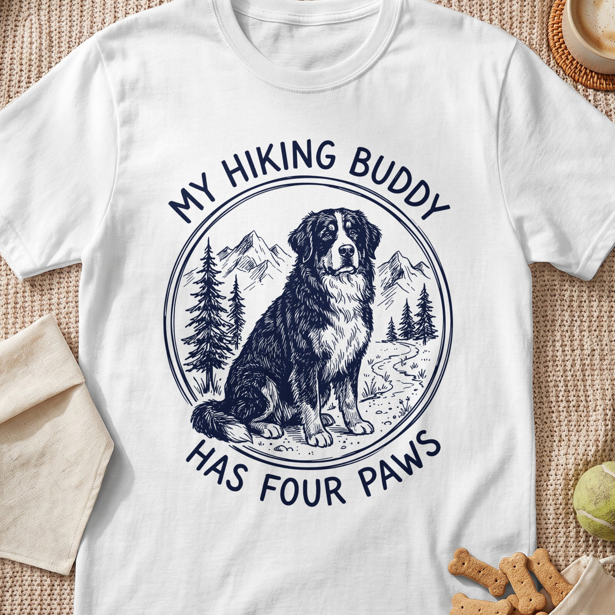 T-shirt with a sketch of a Bernese Mountain Dog and mountains, reads "My Hiking Buddy Has Four Paws".