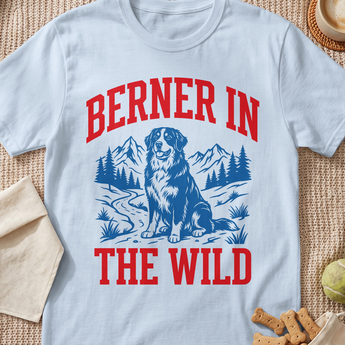 Light blue t-shirt with red text "BERNER IN THE WILD" and a dog in a mountain landscape.