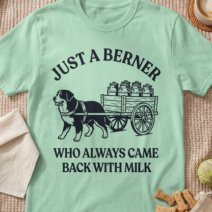 Light green t-shirt with black graphic of dog pulling cart of milk cans and text.