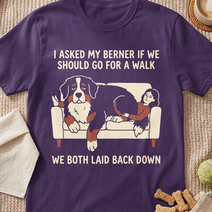 Bernese Mountain Dog and person lounging on couch with text: "I asked my Berner if we should go for a walk. We both laid back down."