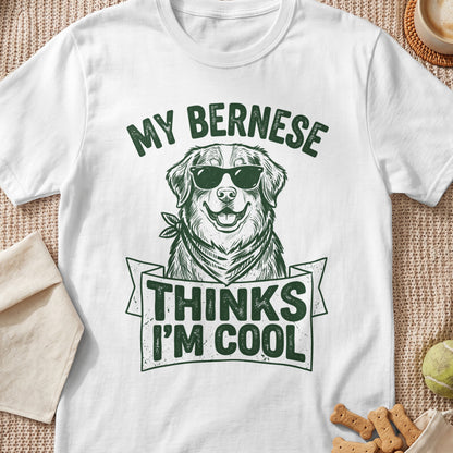 White t-shirt with illustration of a Bernese dog wearing sunglasses and text "MY BERNESE THINKS I'M COOL".