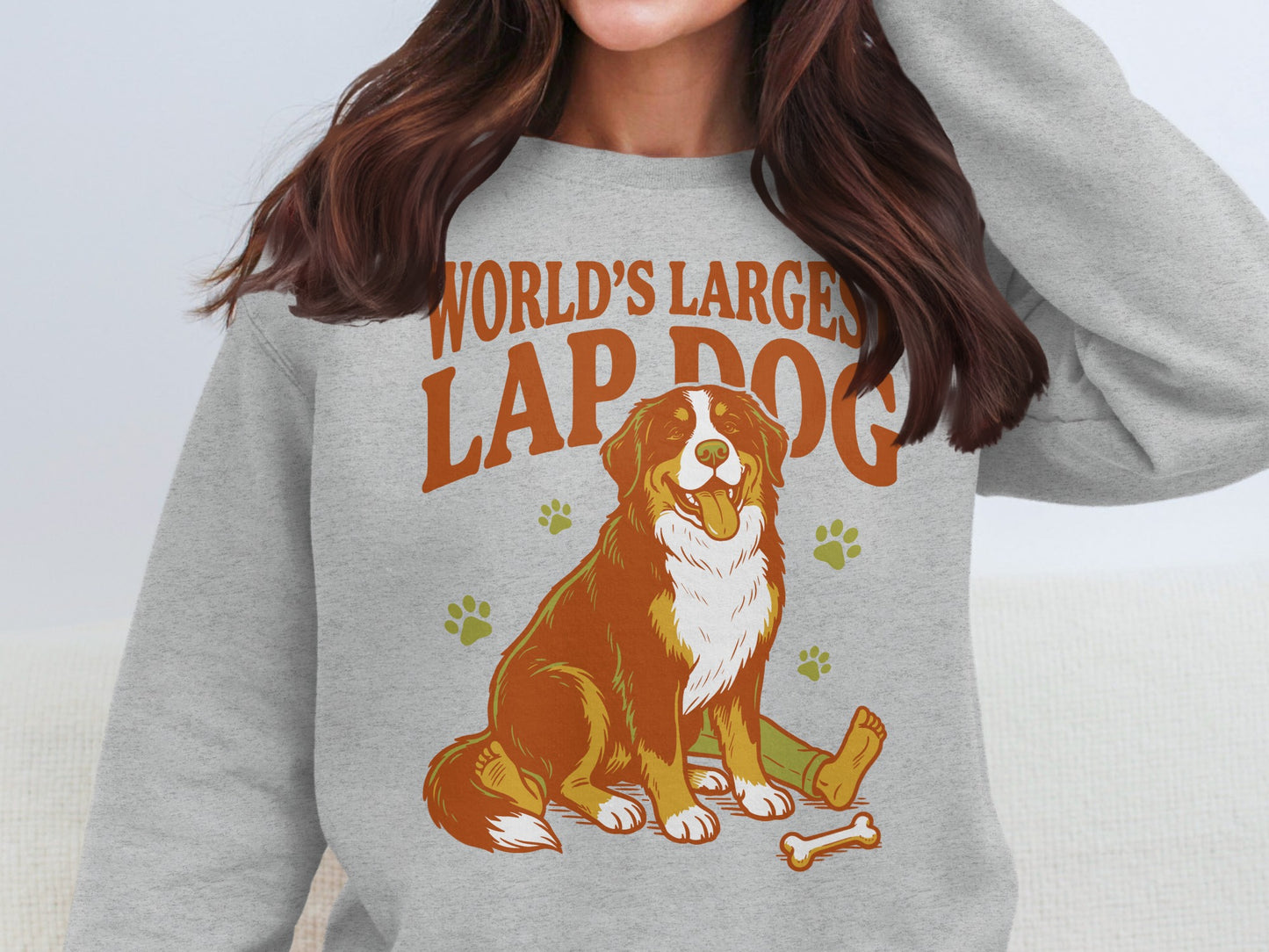 Bernese Mountain dog graphic with text "WORLD'S LARGEST LAP DOG" on sweatshirt.