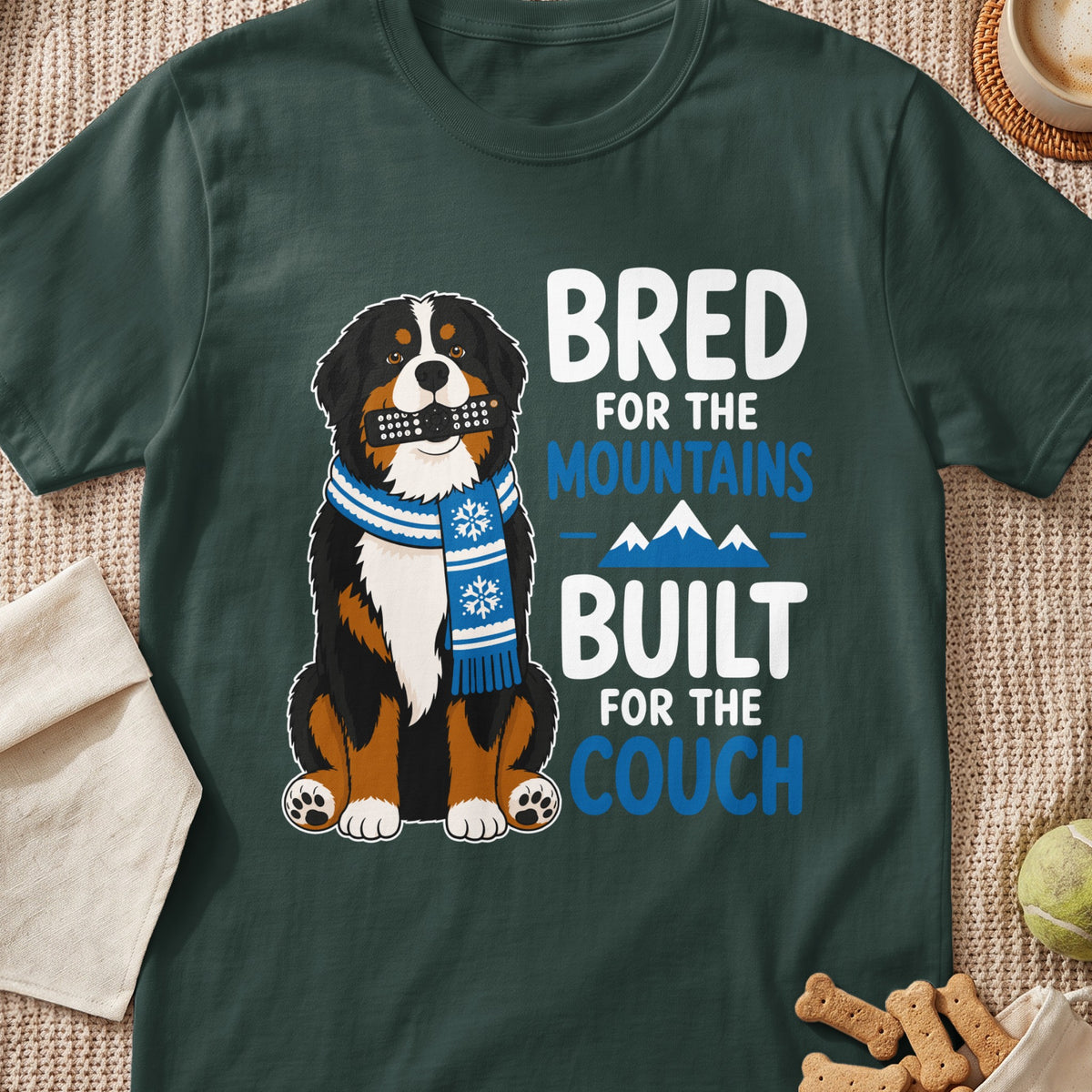 Bernese Mountain Dog wearing scarf, holding remote, with text "Bred for the mountains, built for the couch."