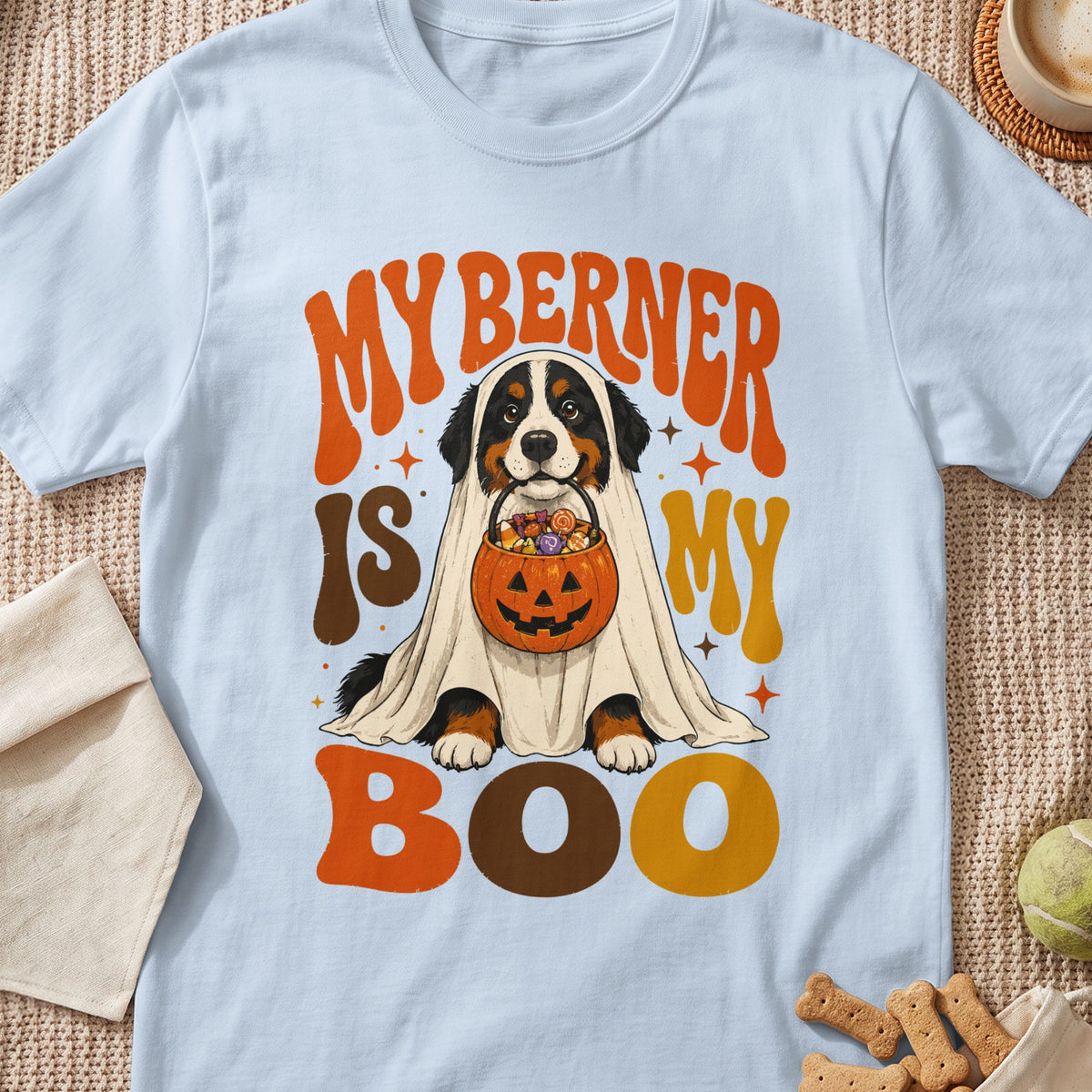 Bernese Mountain Dog wearing ghost costume, holding Halloween candy bucket with text "My Berner Is My Boo".