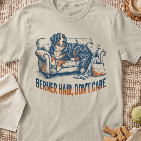 Bernese Mountain Dog resting on a couch with text "BERNER HAIR, DON'T CARE".