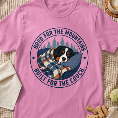 Bernese mountain dog wrapped in blanket on couch, "Bred for the Mountains Built for the Couch" text.