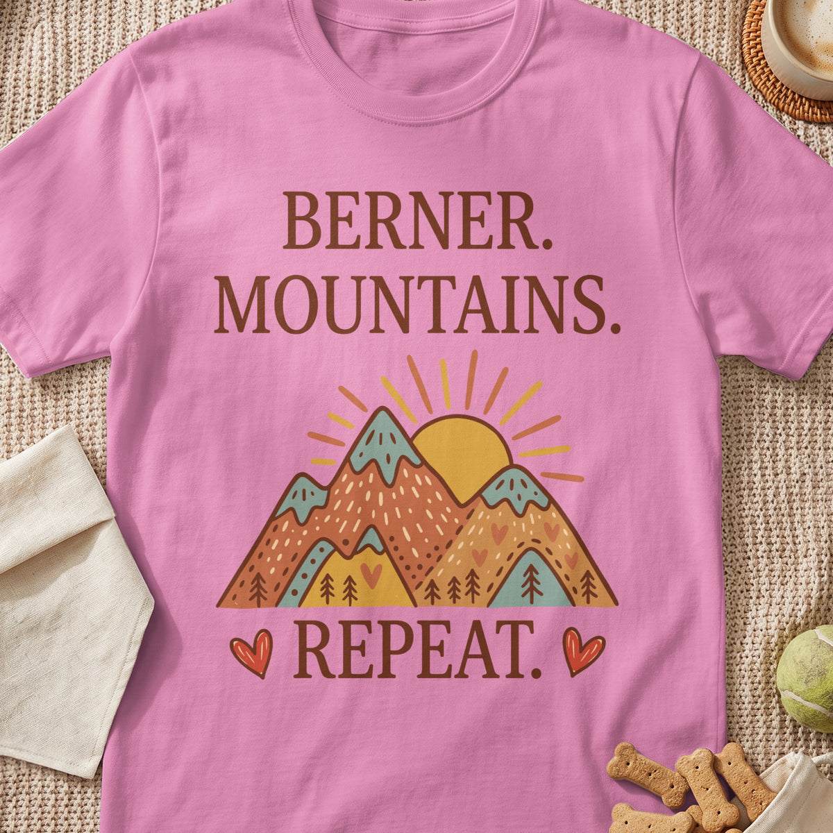 Pink t-shirt with "Berner. Mountains. Repeat." text and mountain graphic.