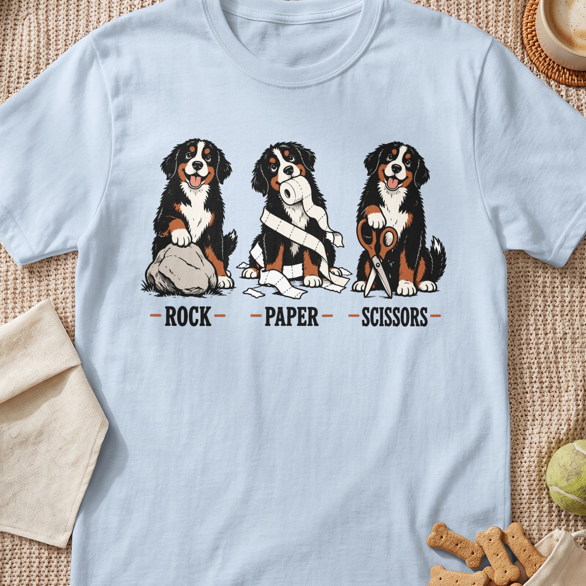 Bernese Mountain Dogs playing rock, paper, scissors with text below.