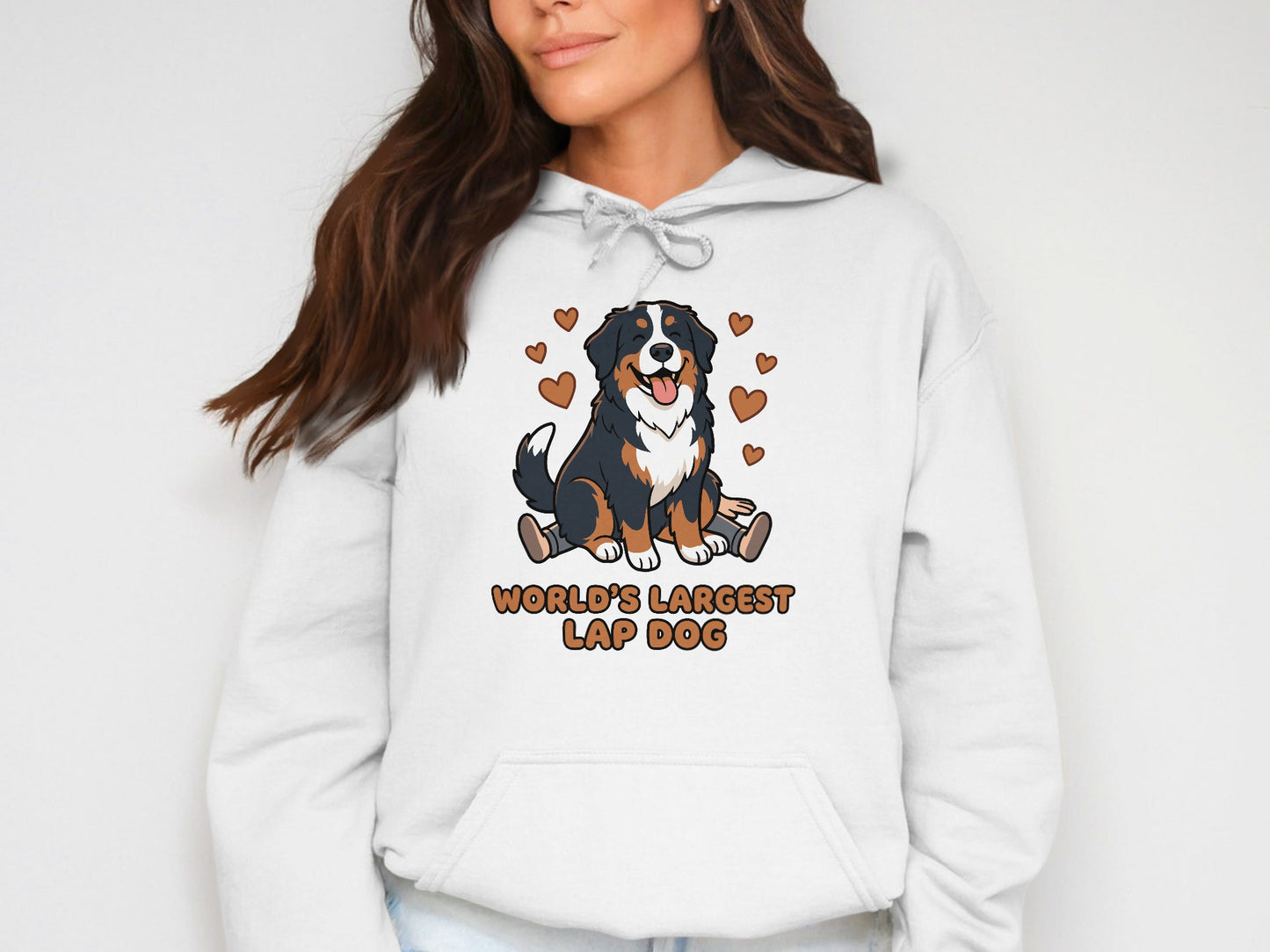 White hoodie on a woman with a cartoon Bernese Mountain Dog and "World's Largest Lap Dog" text.