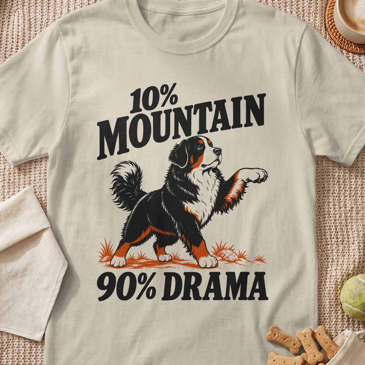 A beige t-shirt printed with a Bernese Mountain Dog graphic and the text 10% Mountain 90% Drama.