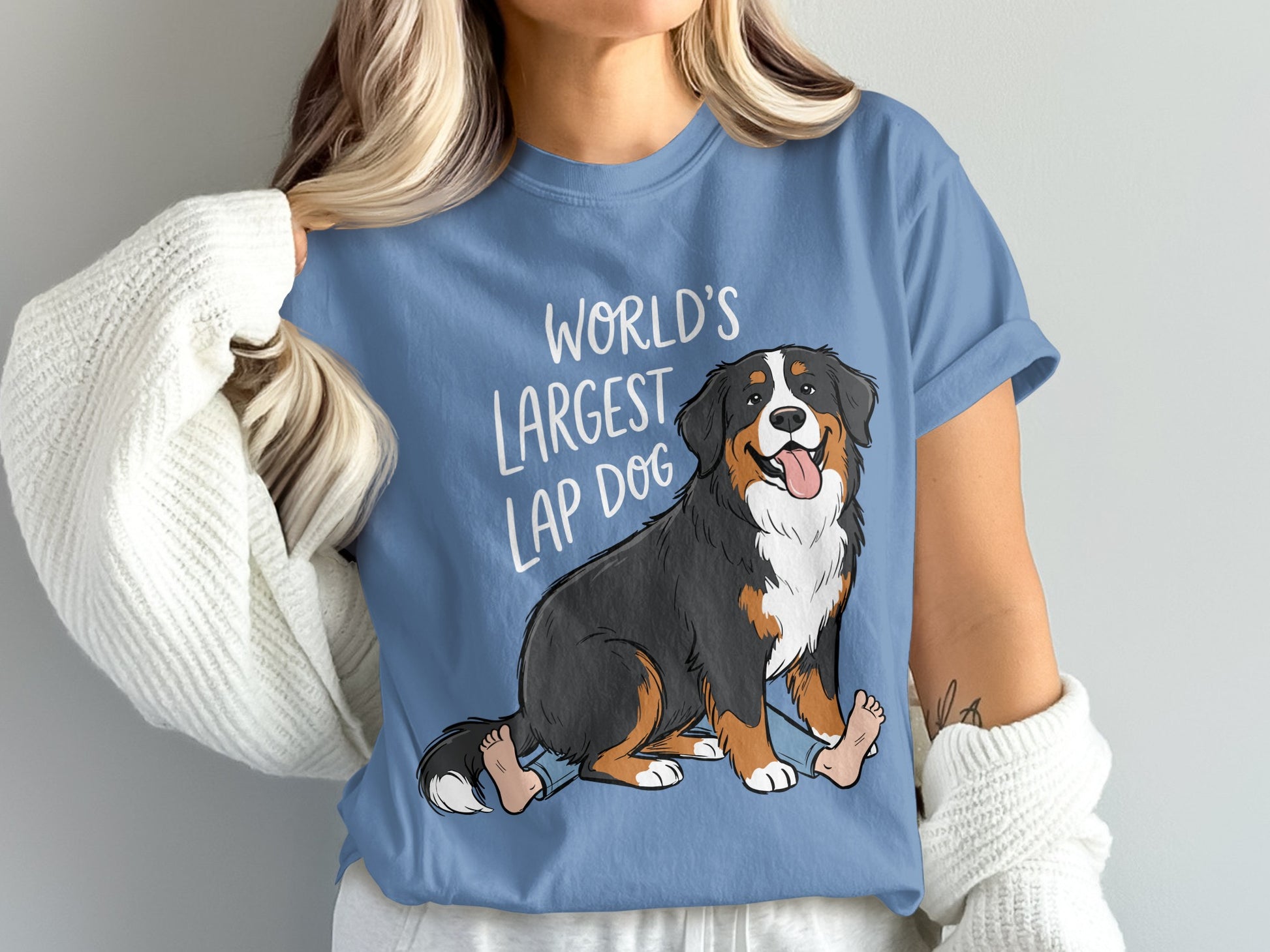 Bernese Mountain Dog cartoon with "World's Largest Lap Dog" text on blue t-shirt.