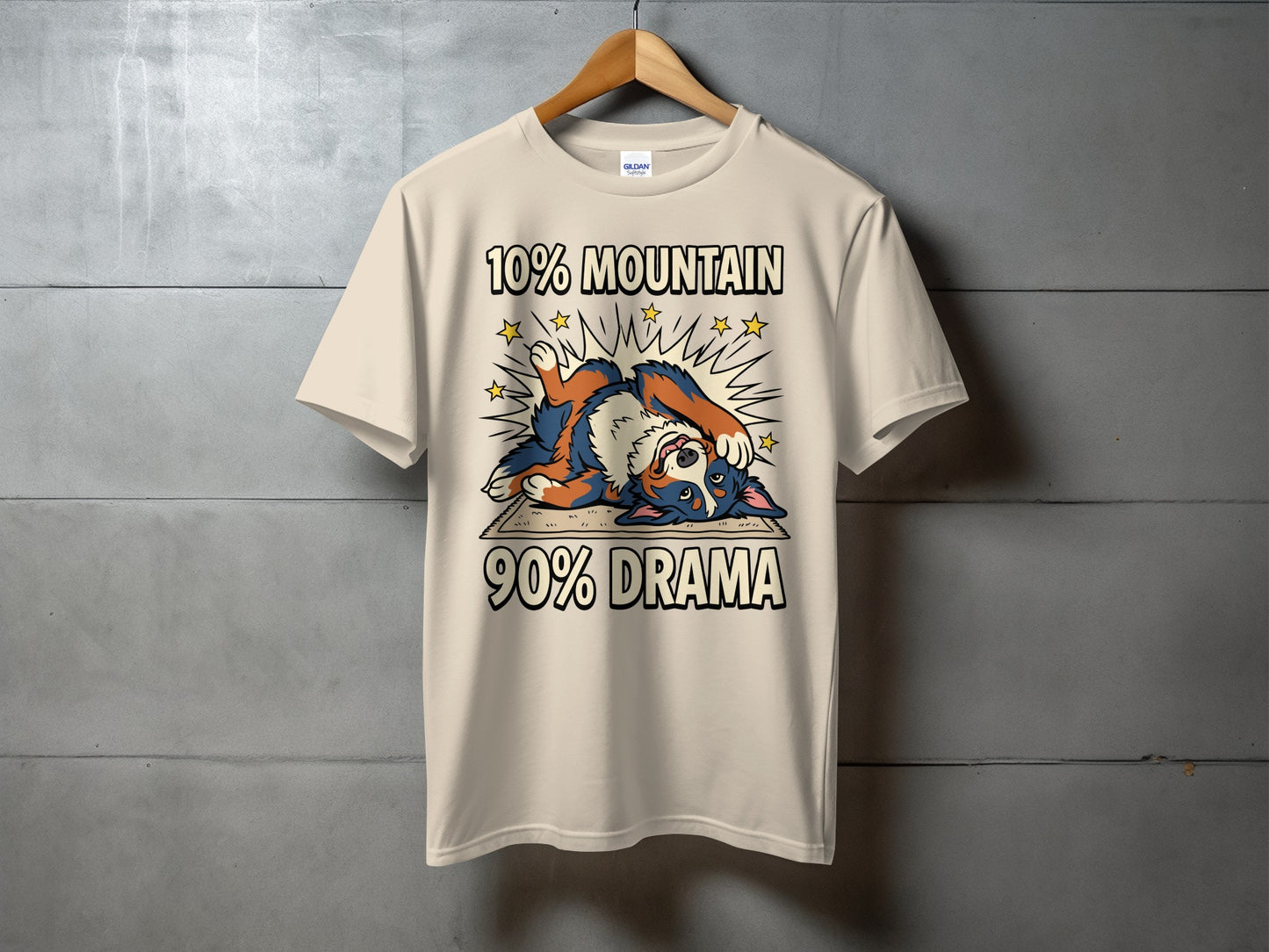 T-shirt with a cream color and graphics of a dog and text "10% MOUNTAIN 90% DRAMA".