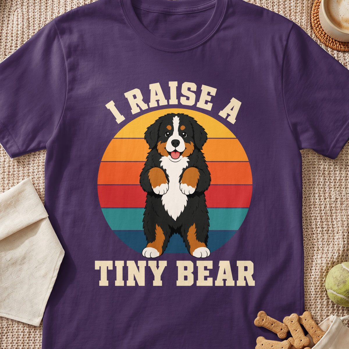 Bernese Mountain Dog graphic with text "I RAISE A TINY BEAR" on purple shirt.