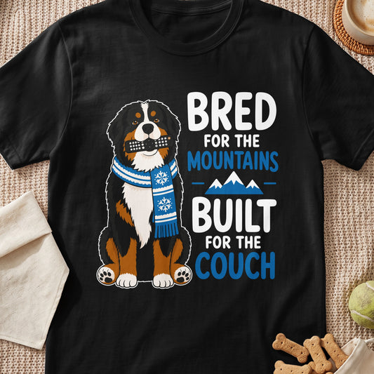 Bernese Mountain Dog with remote and scarf, text "Bred for the mountains, built for the couch".
